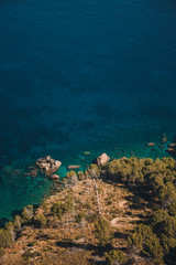 Aerial view of turquoise and crystal clear water at the cliff coast. Mallorca coastline, Balearic Islands, Drone.