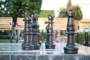 Gigantic chessboard with chessmen outdoors