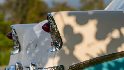 details of the back of a white classic cuban car with back lights