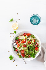 vegan ketogenic spiralized courgette salad with avocado tomato pumpkin seeds