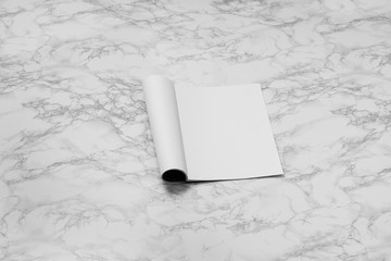 Mock-up magazine, newspaper or catalog isolated on white marble background.
