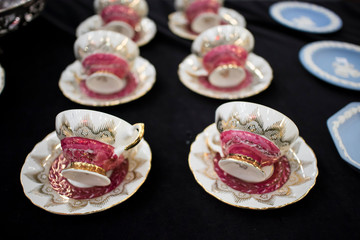 multicolored tea and dining sets at flea market for sale