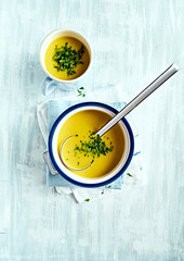 Cream of potato and leek soup with turmeric, topped with fresh parsley