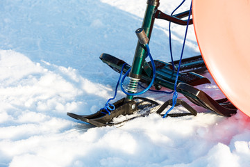 Beautiful children's snow scooter ski for kids in the snow.