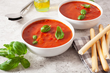 tomato and bell pepper vegetarian soup on green background