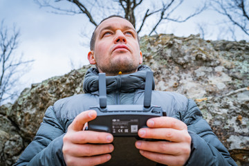 Man holding a drone controller.