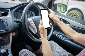 hand holding a mobile phone in the car