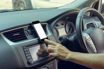 hand holding a mobile phone in the car