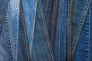 Denim fashion. Blue jeans background. Seams and stitches of different shades and textures. Top view.