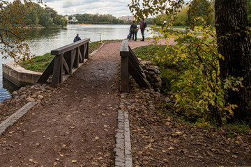 Autumn. Wooden bridge on the background of the pond in the park Kuskovo. Moscow