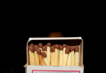 box of wooden matches on a black background