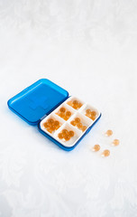 medicine fish oil in a blue pill box