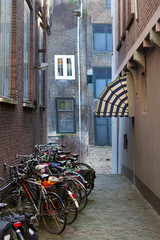 Old small vintage street with bicycles and an awning