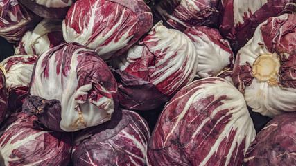 Fototapeta na wymiar Healthy purple violet and white cabbage heads as organic vegetable in a grocery store market for sale as a part of a healthy vegan diet