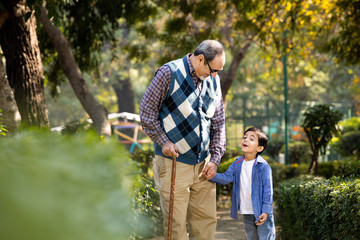 Cheerful grandfather spending leisure time with grandson