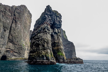 Fototapeta na wymiar Spectacular rock formations in Faroe islands coast