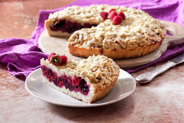 Homemade berry shortcrust pie with crumble on wooden board