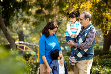 Happy grandparents spending leisure time with grandchildren