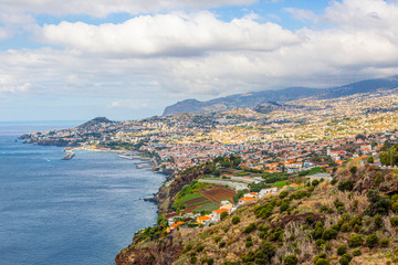 Naklejka na ściany i meble Panoramic picture over the capitol city of Funchal on the Portugese island of Madeira at daytime