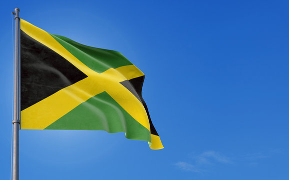 Jamaica flag waving in the wind against deep blue sky. National theme, international concept. Copy space for text.