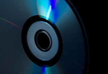 compact-disc in hand on a black background