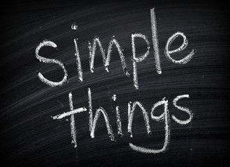 The phrase Simple Things written by hand on a blackboard as a reminder