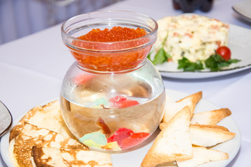 red caviar in a transparent bowl