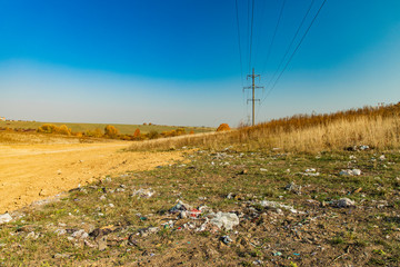environmental disaster garbage polluted field country side space summer time horizon background...