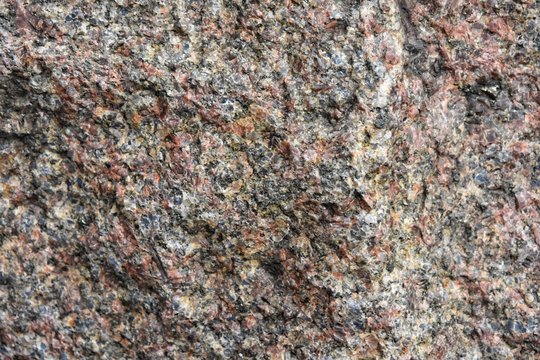 Structured granite surface with selective focus. Stone background with rough texture. Natural unpolished stone. Building materials. Marble 