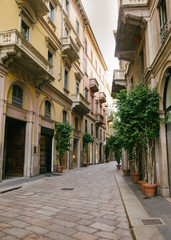 Narrow street of the old medieval city of Italy, beautiful architecture of houses, streets in paving stones.
