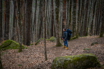 Obraz premium Man walking alone in deep autumn forest