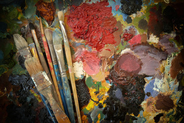 artist's old real brushes on a dark contrasting colorful palette.