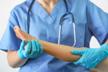  Doctor holding patient leg, examination of patients in the hospital. Surgeon, surgical doctor,...