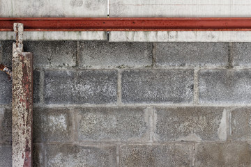 Concrete block wall background and texture with Rusted beams and columns left and top of frame.