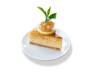 Brown cake piece with honey and lemon topping and green tea leaf on top.