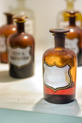 Big old amber pharmacy bottles, close up.