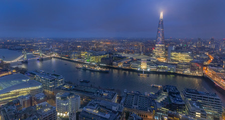 Night aerial view of Thames river, Tower Bridge and The Shard in London, England