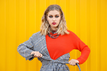 Portrait of fashionable young woman on color background