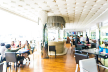 Fototapeta premium Abstract blurred bokeh people sitting in hotel restaurant