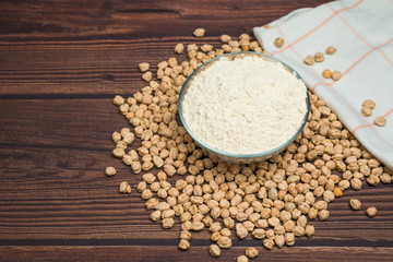 chickpea flour. organic healthy cereals. flour in a plate on a wooden background. natural vegetarian vegetable protein . the view from the top, place for text