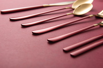 The exquisite tableware, knives, forks and plates used by the royal family are placed on the red background