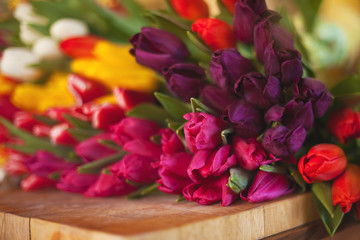 A huge multi-colored bouquet of tulips lies on a table in a flower shop. Preparing for Women's Day and Valentine's Day