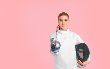 Young female fencer on color background