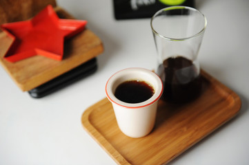 Stylish served specialty alternative black coffee. Bamboo tray, carafe. Ceramic cup without a handle. Aesthetics coffee