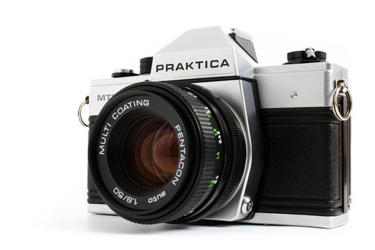 Prague, CZECH REPUBLIC - DECEMBER 24, 2018: Old retro vintage SLR camera Praktica MTL5 for 35mm film made by German company Pentacon between 1983 and 1985 laid on white background