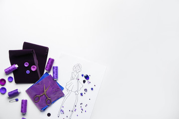 Set of tailor's supplies with sketch on white background