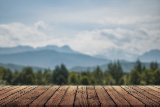 wooden table for advertising with the Alpine mountains in the background