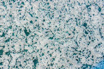 Fototapeta na wymiar The texture of the blue ice. The frozen water. Ice background