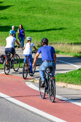 Radfahrer befahren einen Übergang von der Straße auf einen kombinierten Rad- und Fußweg