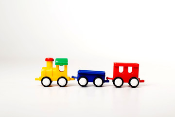 children's toy plastic multicolored locomotive on a white background. space for text